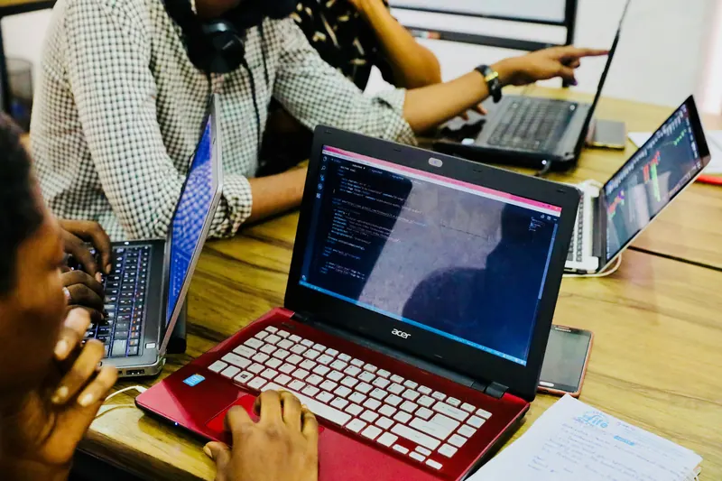 Developers working side by side on their laptops
