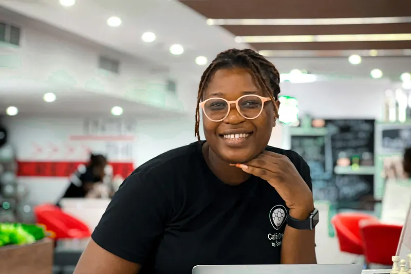 A smiling developer working on her laptop